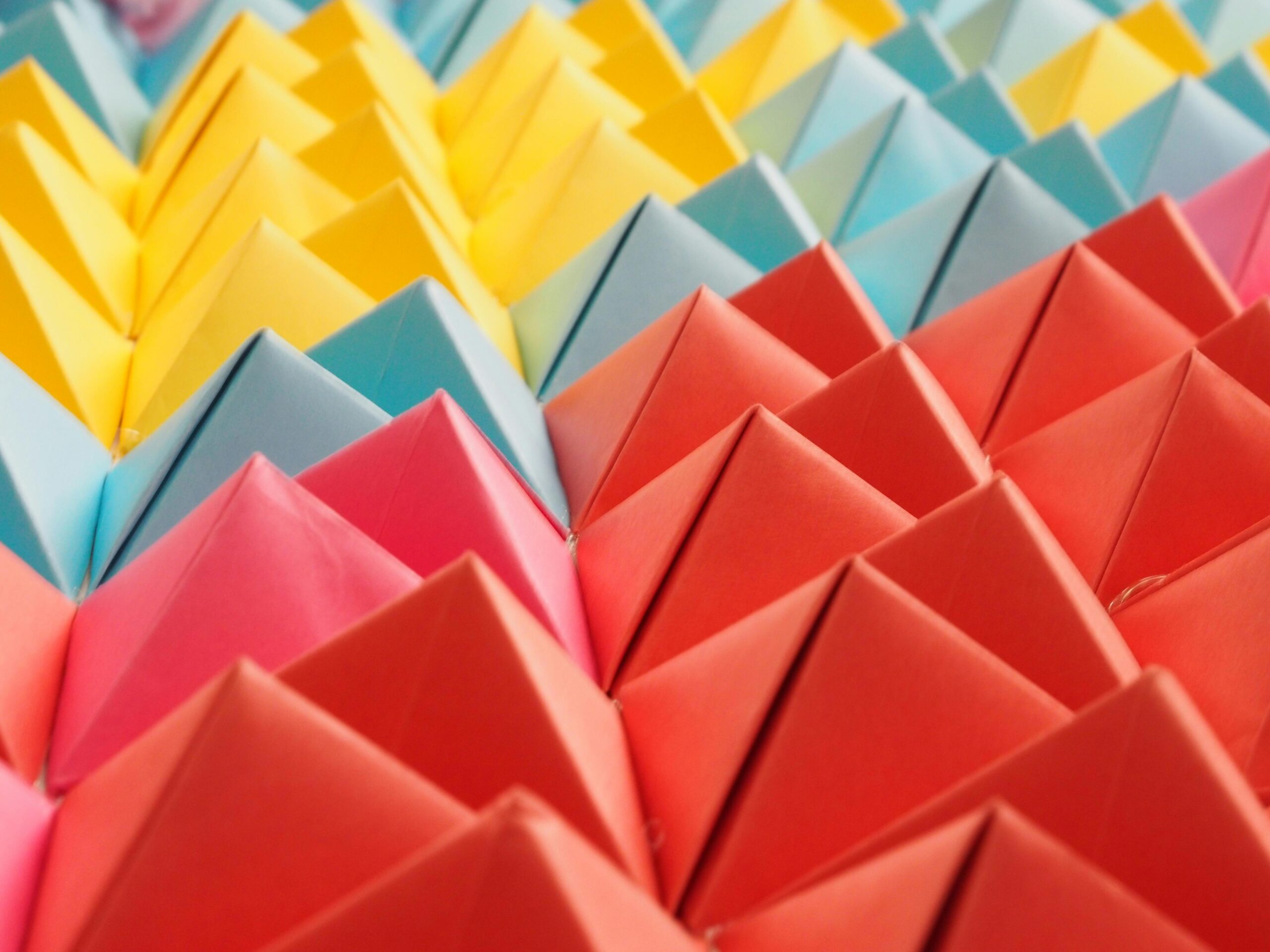 Vibrant folded paper pyramids in a colorful geometric pattern.